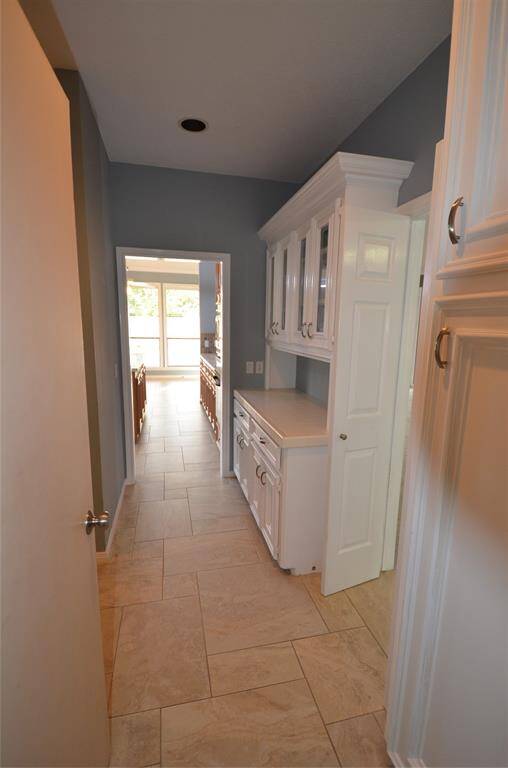 As you enter from garage there is pantry storage with view to back yard