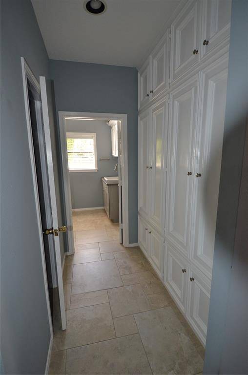 Extended pantry leads to utility room and guest half-bath