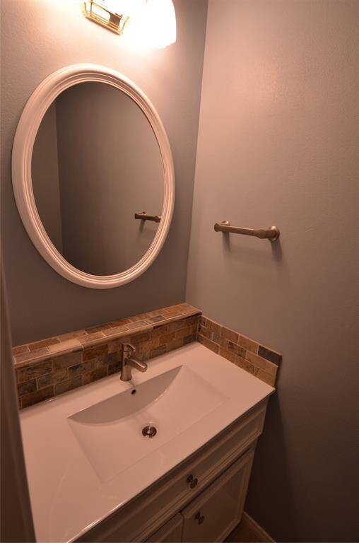 Guest half-bath with custom cabinet storage