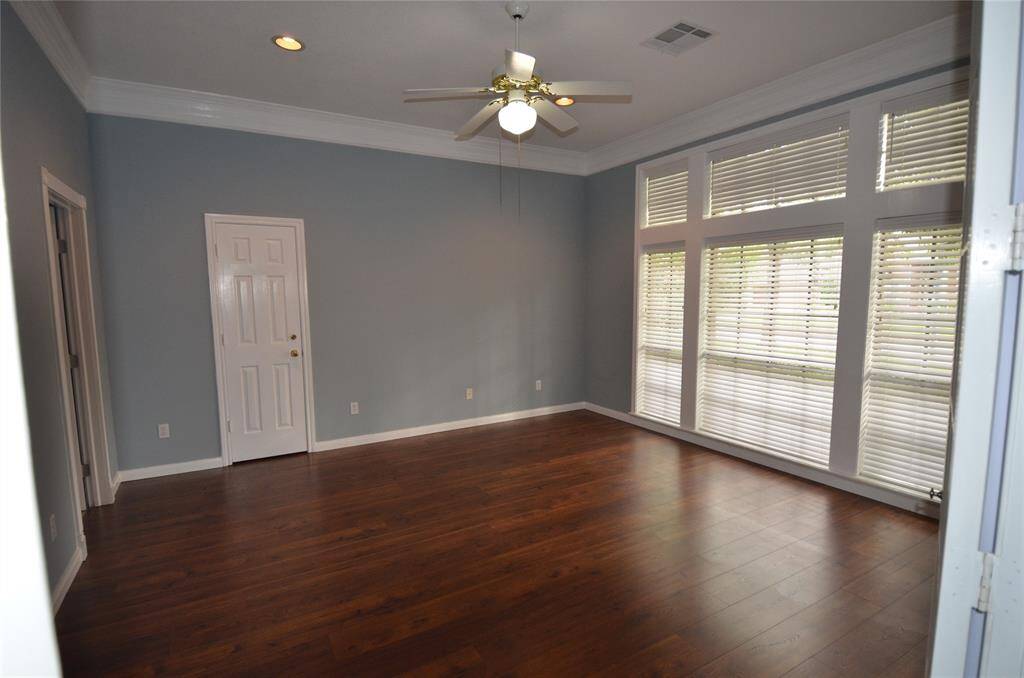 French doors lead to large front bedroom to the right of entry with walk-in closet
