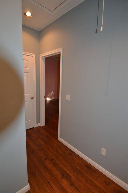 Small hallway isolates middle BR from living area and features hall closet and attic access