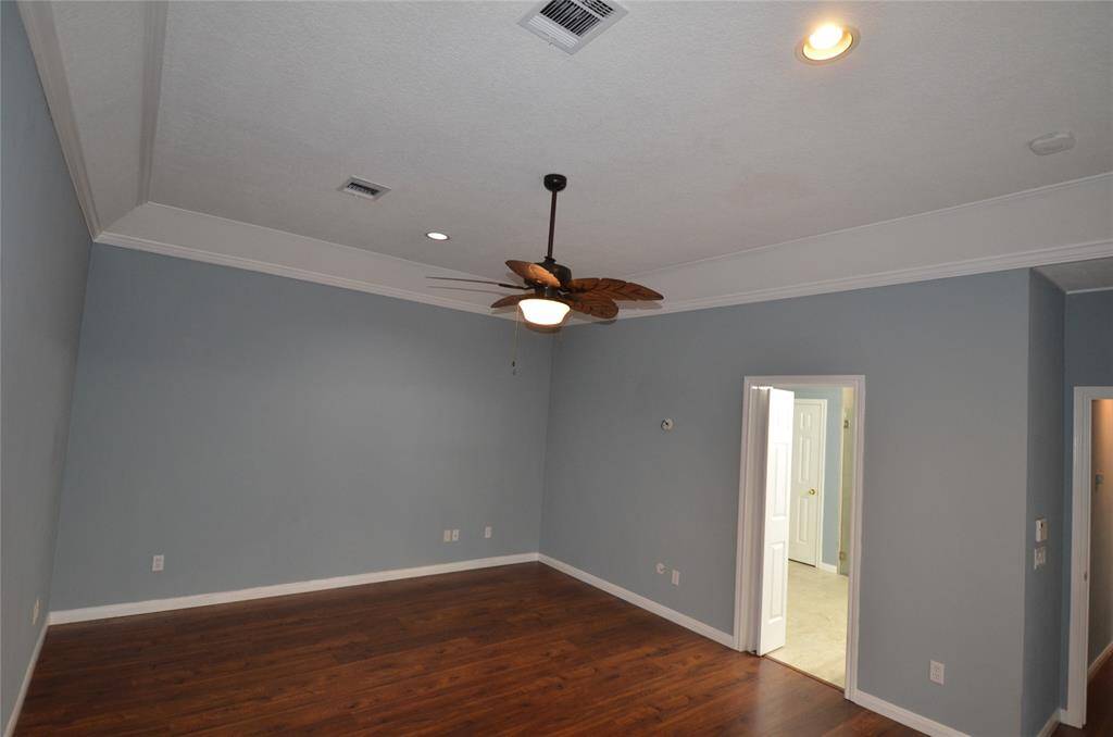 Primary BR separated from living area by long hallway with window views of backyard