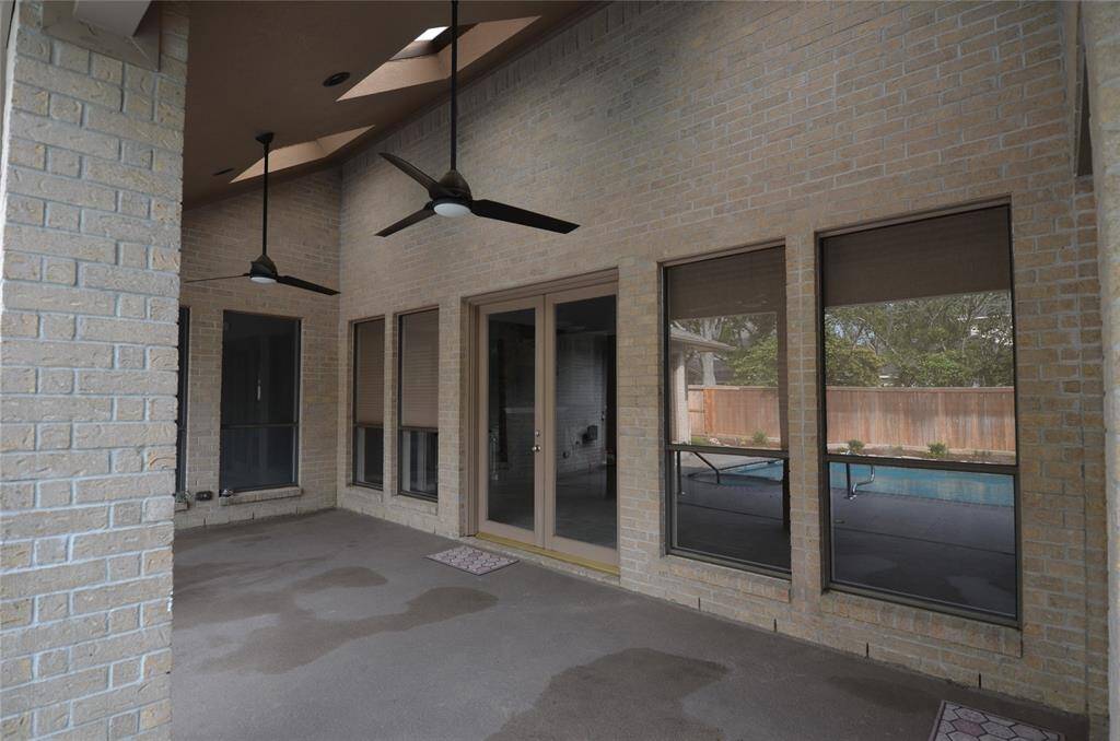 Back patio with overhead fans and skylights with easy access to living areas
