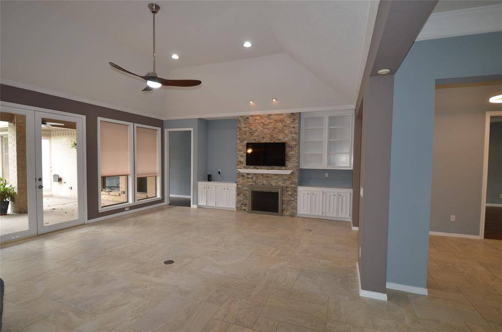 LR features gas fireplace, custom cabinets and vaulted ceiling