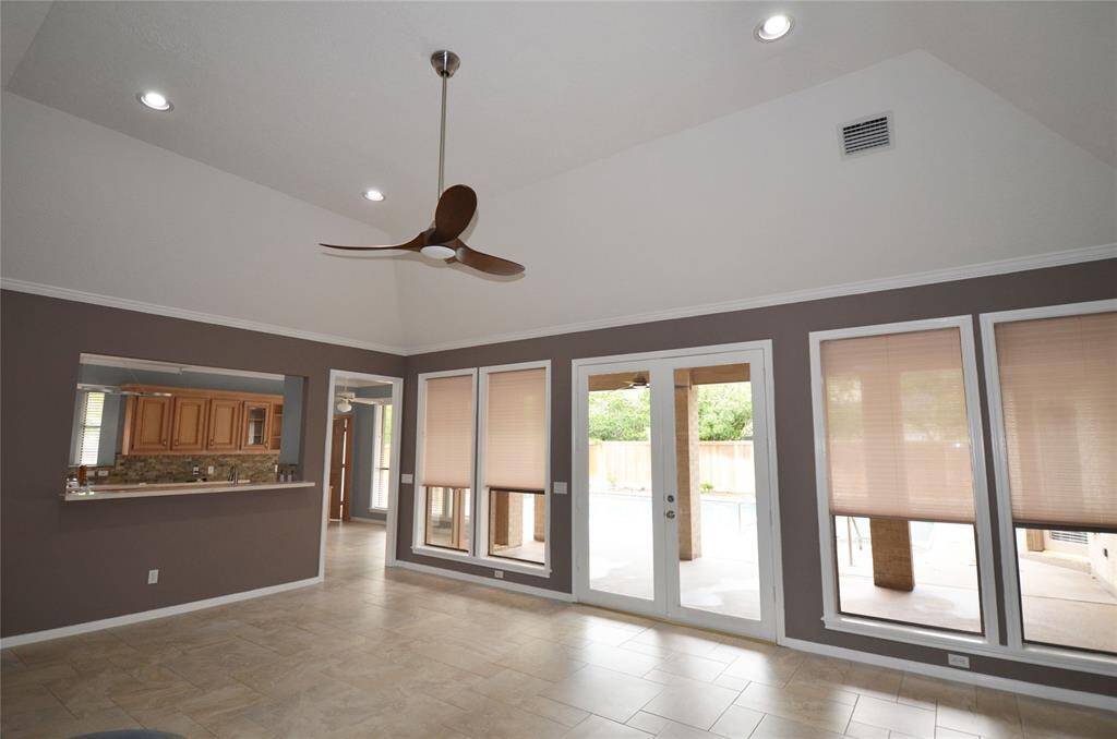 LR features large French doors that lead to patio, countertop bar that opens to kitchen