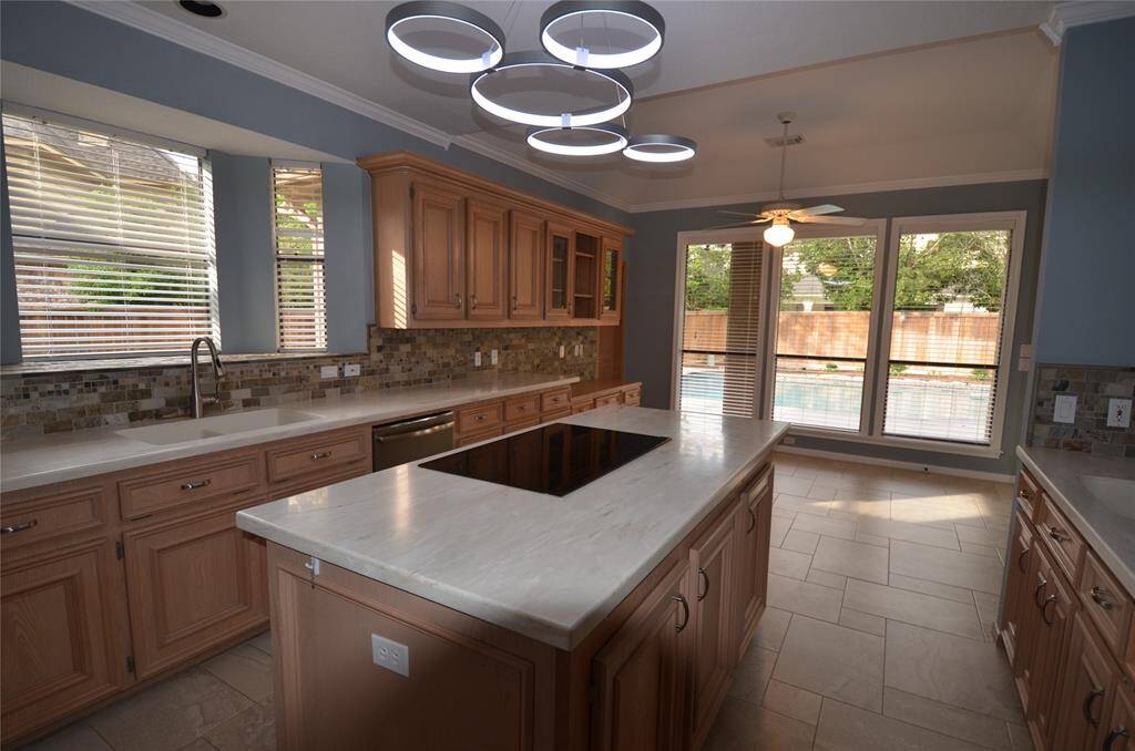 Kitchen features large island with induction stovetop