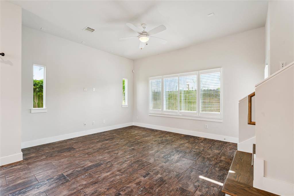 Your living room with large windows that let in tons of natural lighting, equipped with plantation shutters.