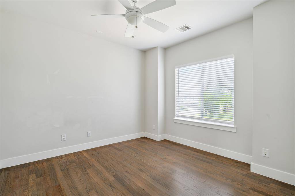 Another secondary bedroom with a large custom window that lets in tons of natural lighting.