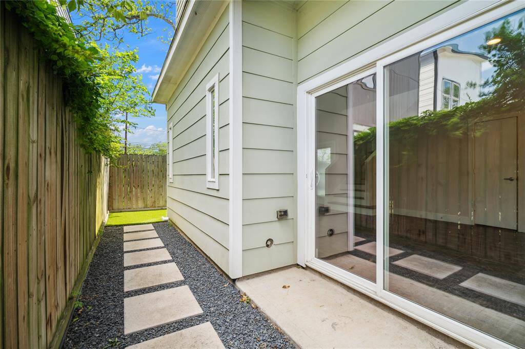 Your side yard with plenty of space for a grill or smoker, perfect for game day or just for hosting family and friends.