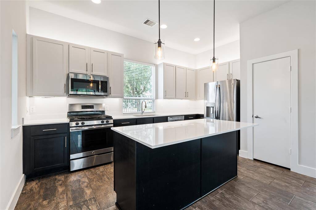 Your kitchen features two-tone cabinets with a large island that's perfect for hosting and entertaining family and friends.