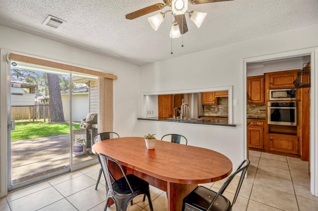 Another look at the dining space as it opens to your backyard and the galley kitchen.