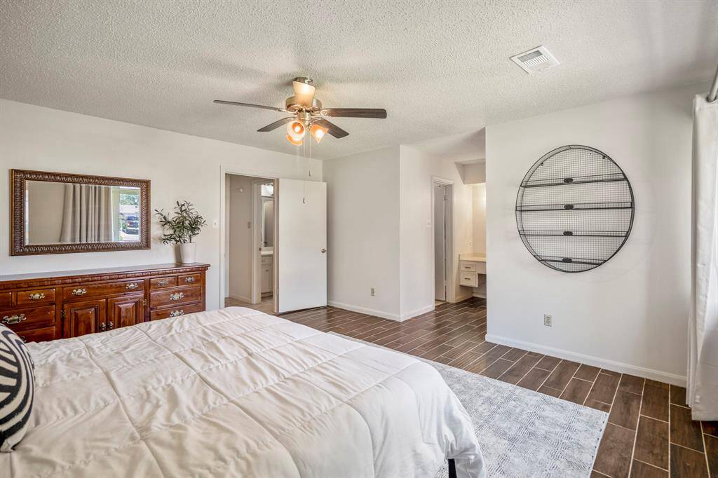A look at this primary bedroom with a view of the hallway and the entry into the primary bath.