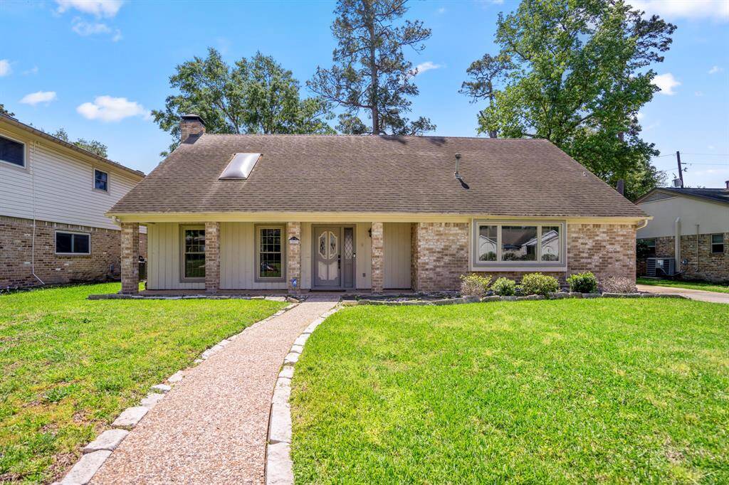A beautiful elevation greets you at 207 Greenforest with a lush front lawn.