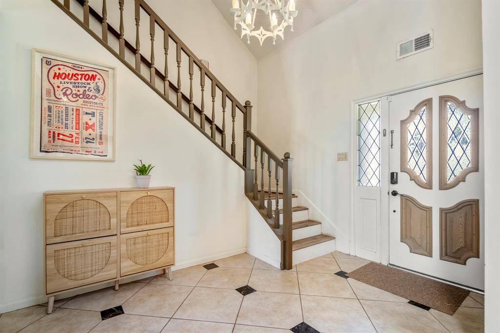 Welcome inside the classic foyer with two story ceilings and a perfect space for entryway furniture.