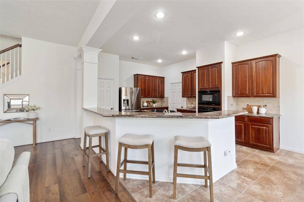 There is additional seating space around the breakfast bar in the kitchen.