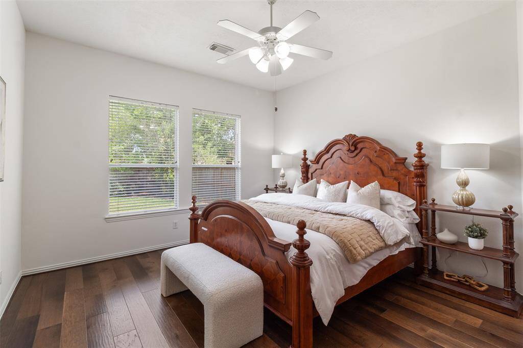 Beautiful wood floors and large windows are also found in the primary bedroom.