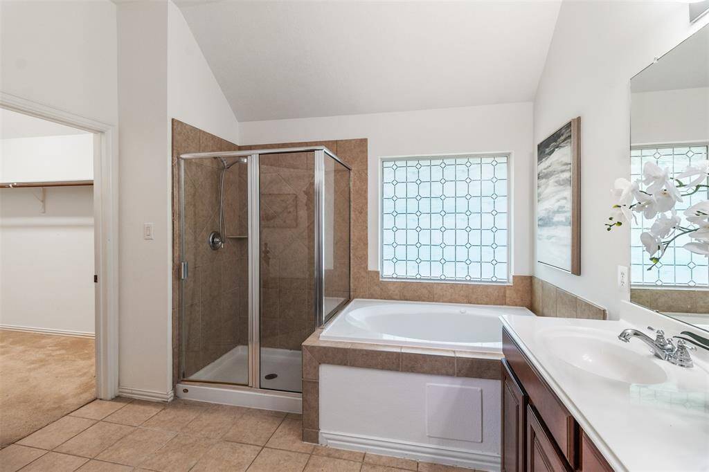 Separate tub and shower can be found in the primary bathroom.