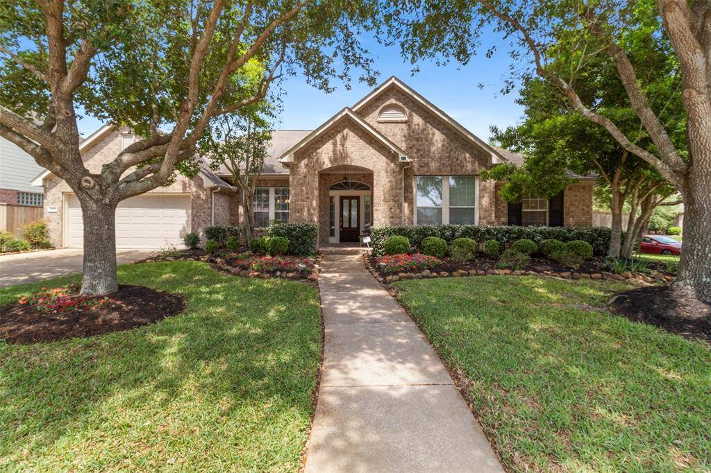 This home invites you in with beautiful landscaping on a large corner lot.