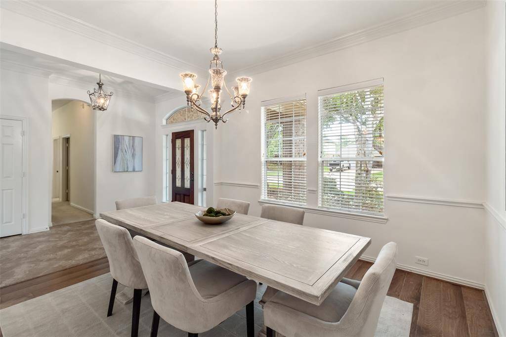 A view of the dining room, entry way and hall that leads to the secondary bedrooms.