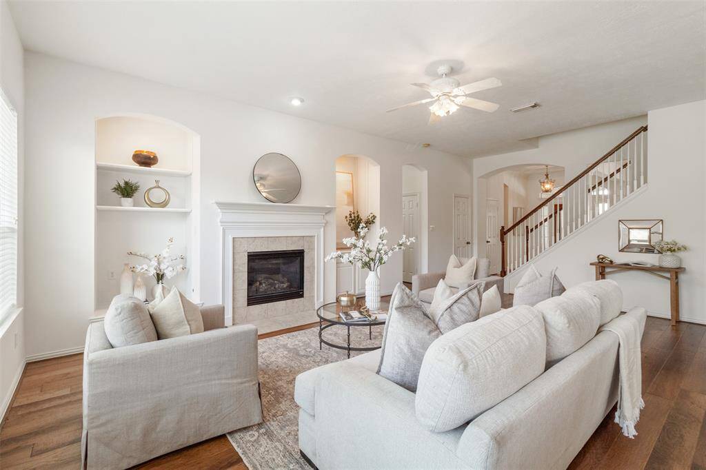 A stair case divides the dining room and living room and leads upstairs to a large gameroom.