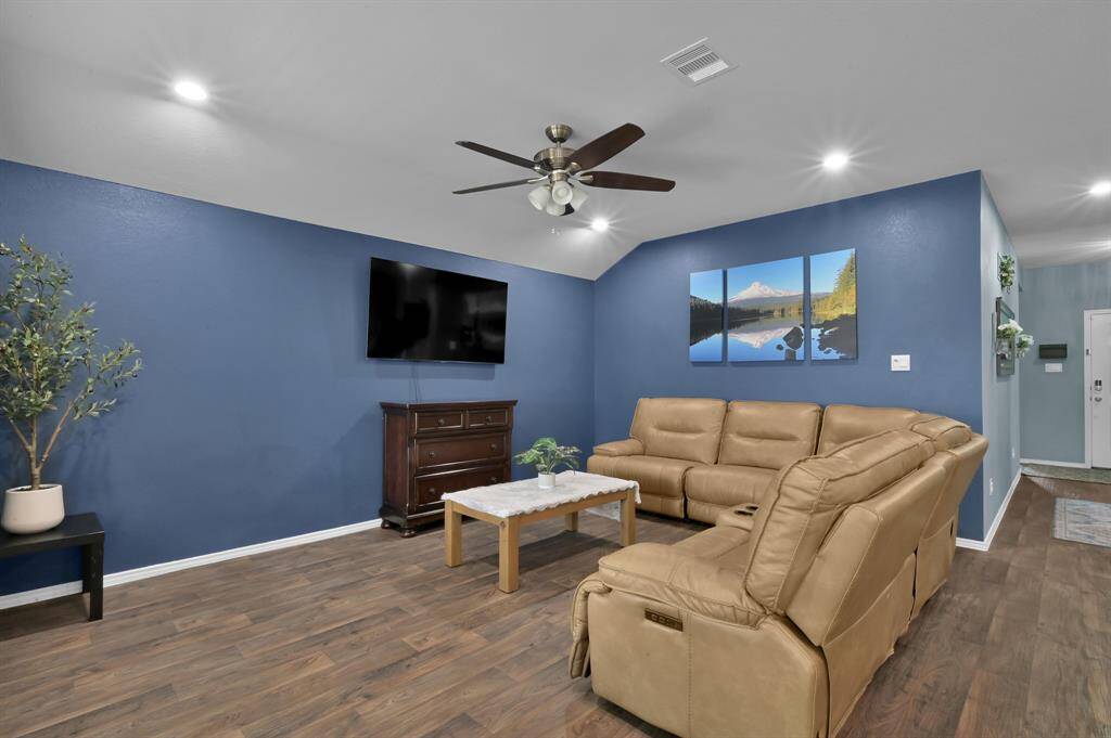 The living room is a fantastic size and can accommodate multiple different options for furniture layout.