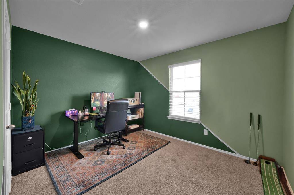 Secondary bedroom that faces the front right side of the home and overlooks the abundant landscaping in the front yard.