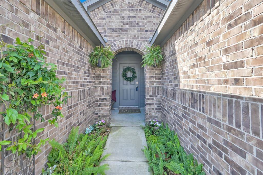 The ferns lining the walkway up to the home create a nice first impression for your guests.