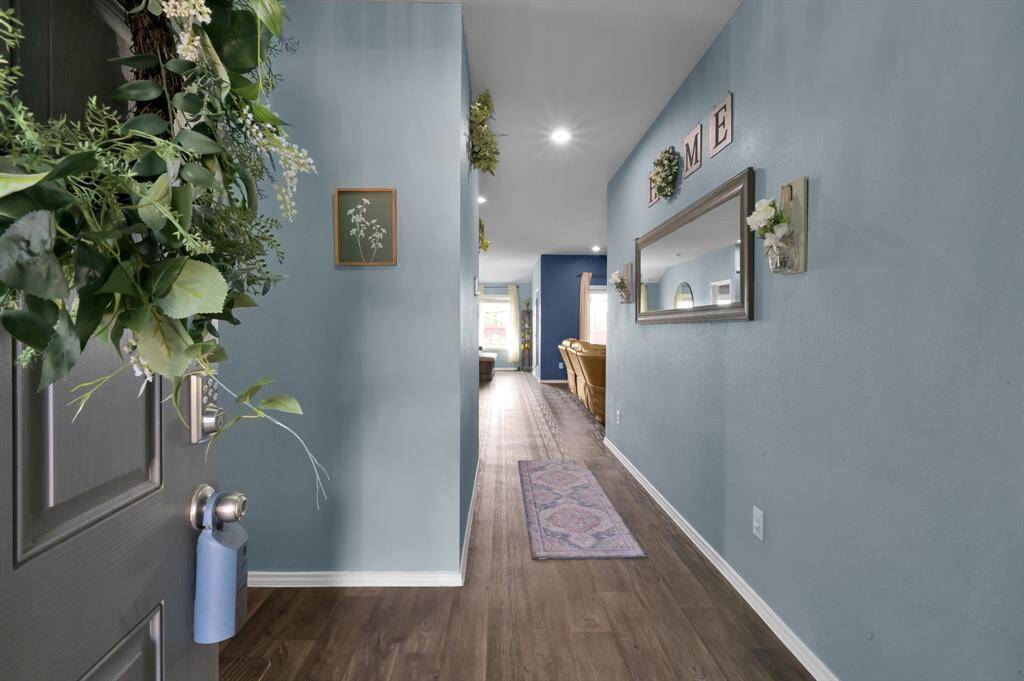 Welcome in! The warm luxury vinyl floors take your eyes straight through to the back of the home.