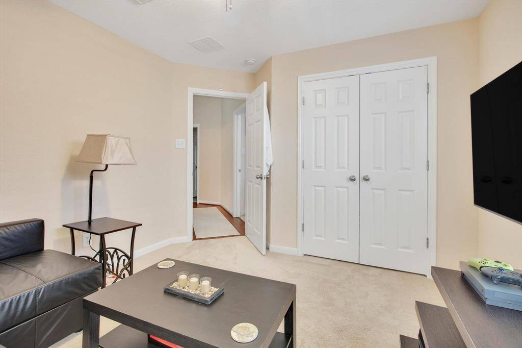 This cozy room features carpeted flooring, neutral walls, and a double-door closet.