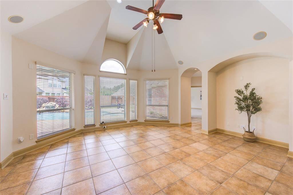 Living room with a stunning wall of windows, filling the space with natural light and showcasing beautiful views.