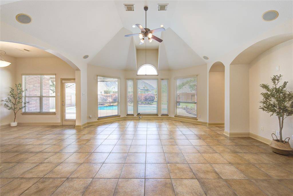 Bright and airy family room with beautiful views of the outdoor pool—perfect for relaxing or entertaining.