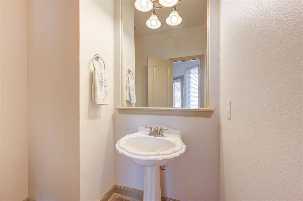 Convenient half bath located just off the family room, ideal for guests.