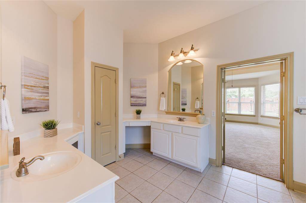 Primary en-suite featuring double vanities, offering plenty of room for a comfortable morning routine.