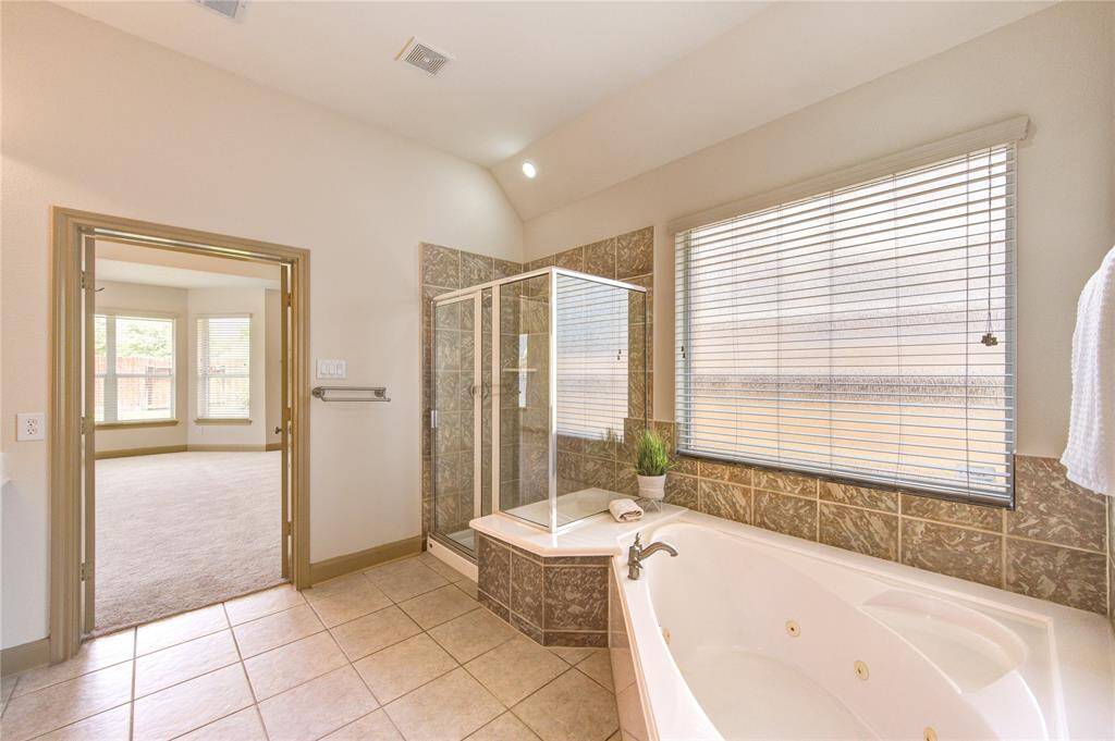 Get ready to forget about routine in this large jetted tub! Tons of natural light and a light color palette is ideal to unwind body and soul.