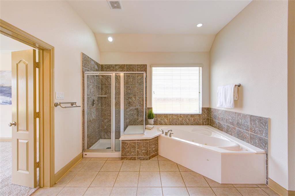 There are so many ways to relax in this home. A glass-enclosed shower mimics the luxury and attention to detail found throughout the rest of this property.