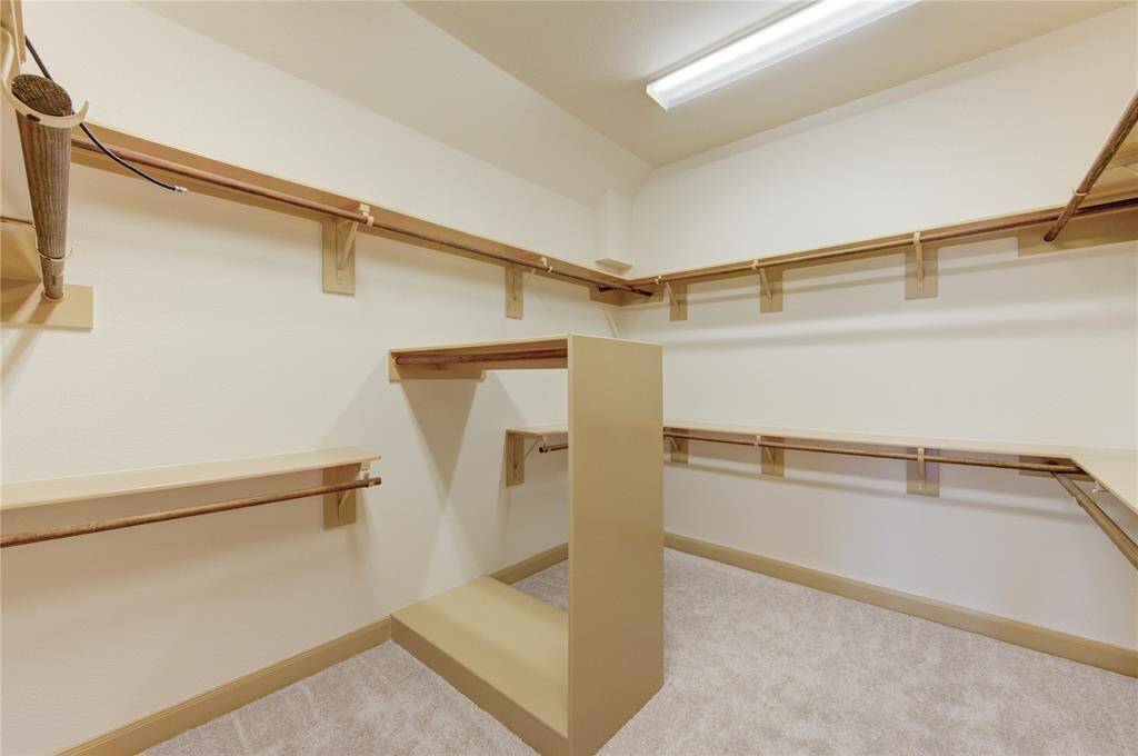 Spacious walk-in closet with plenty of room for all your wardrobe essentials.