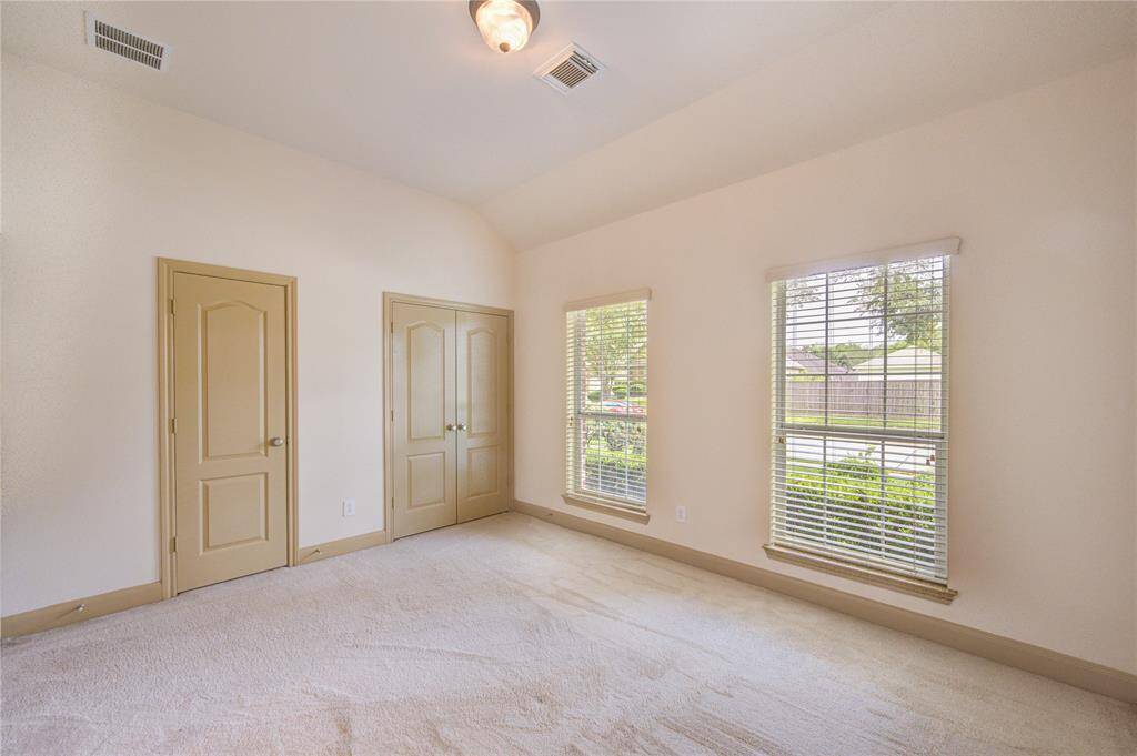 Stretch out and relax in cozy comfort in this secondary bedroom. The light pouring in from the windows makes the space bright and inviting.
