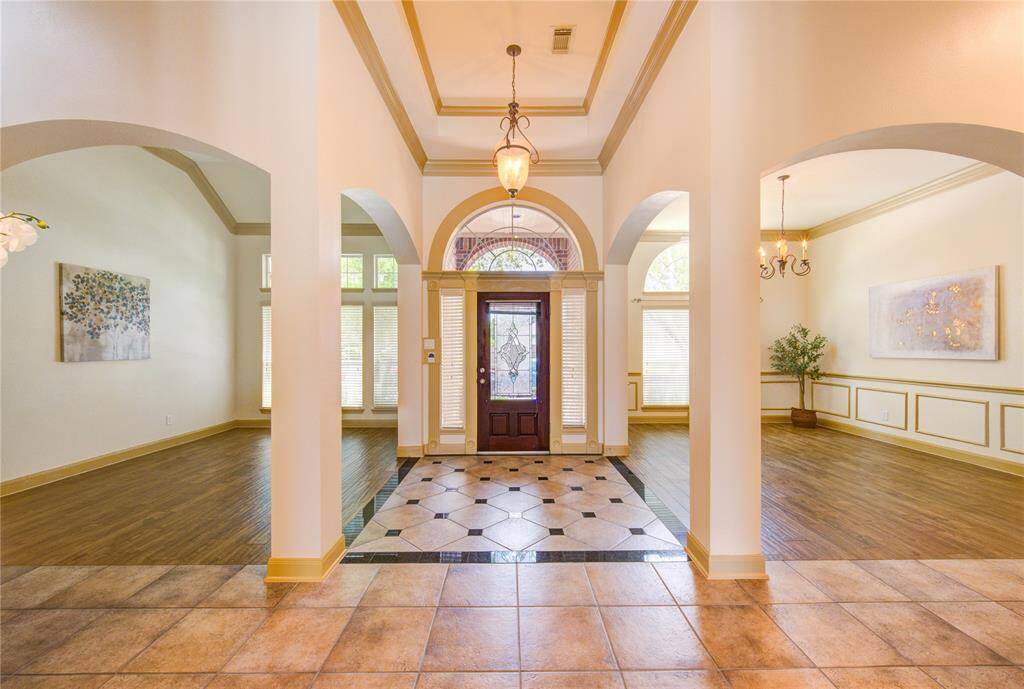 Impressive foyer with soaring ceilings and a grand entrance that sets the tone for the entire home.