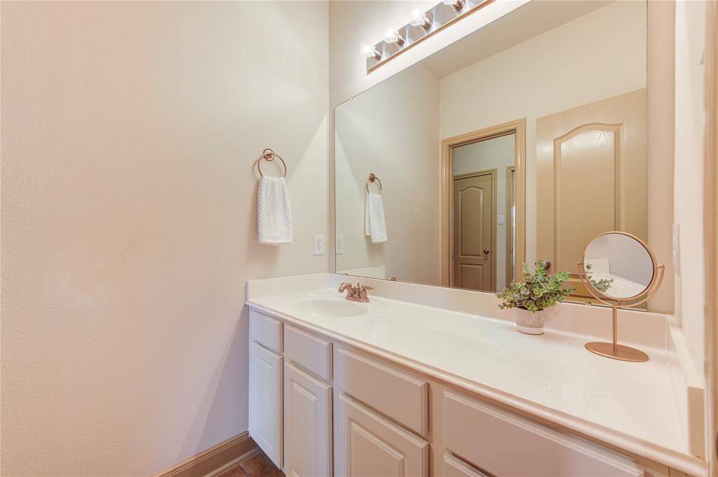 This clean and attractive space is perfect for family and guests alike. A large vanity provides room for all the essentials.