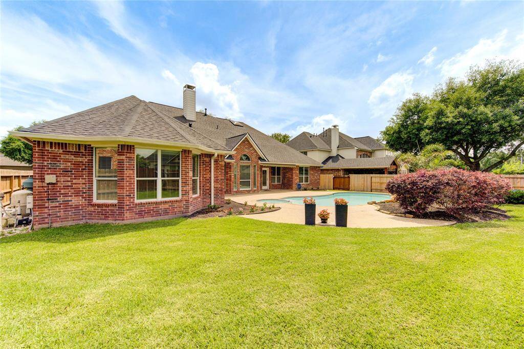 Gorgeous outdoor pool with plenty of deck space for loungers—ideal for sunbathing and entertaining.