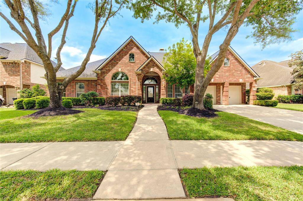 Immaculate landscaping gives this charming home a welcoming feel from the moment you arrive.