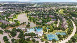 Main pool area with lap pool, splash pad, slides, tennis court, pickleball court, gym and Welcome Center.