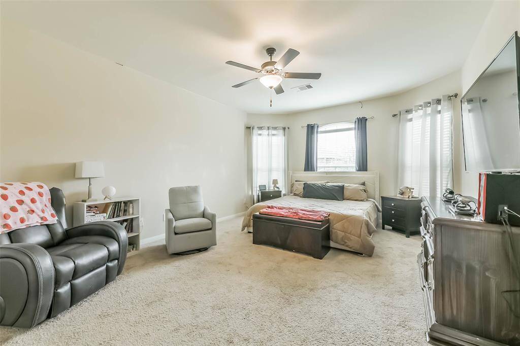 Primary bedroom with large windows  providing plenty of natural lighting