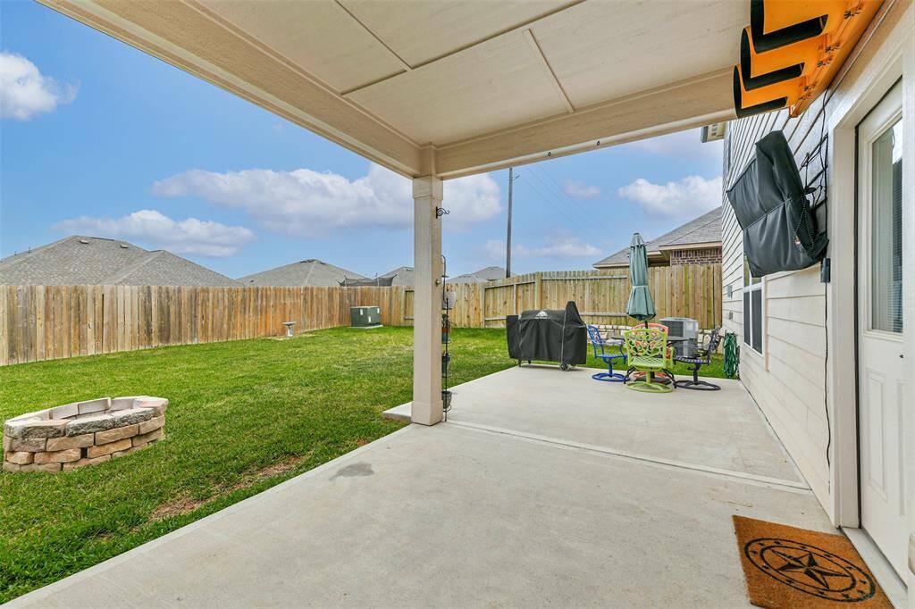 Covered back patio and extended concrete area for family fun, BBQ'g or entertaining