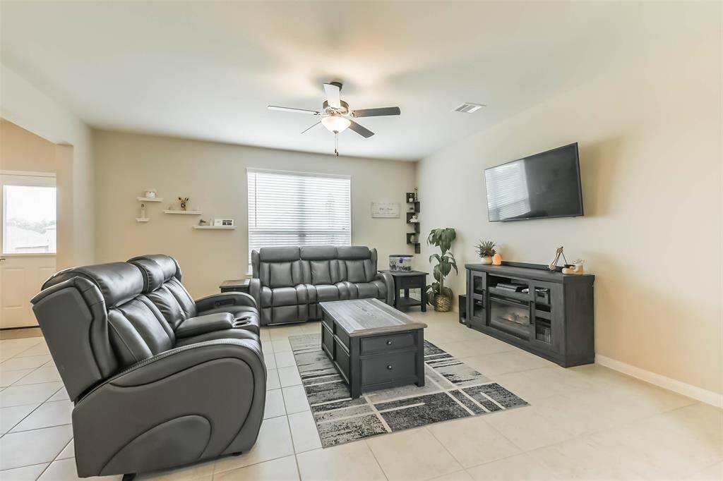 Spacious living room with large windows looking out over the backyard