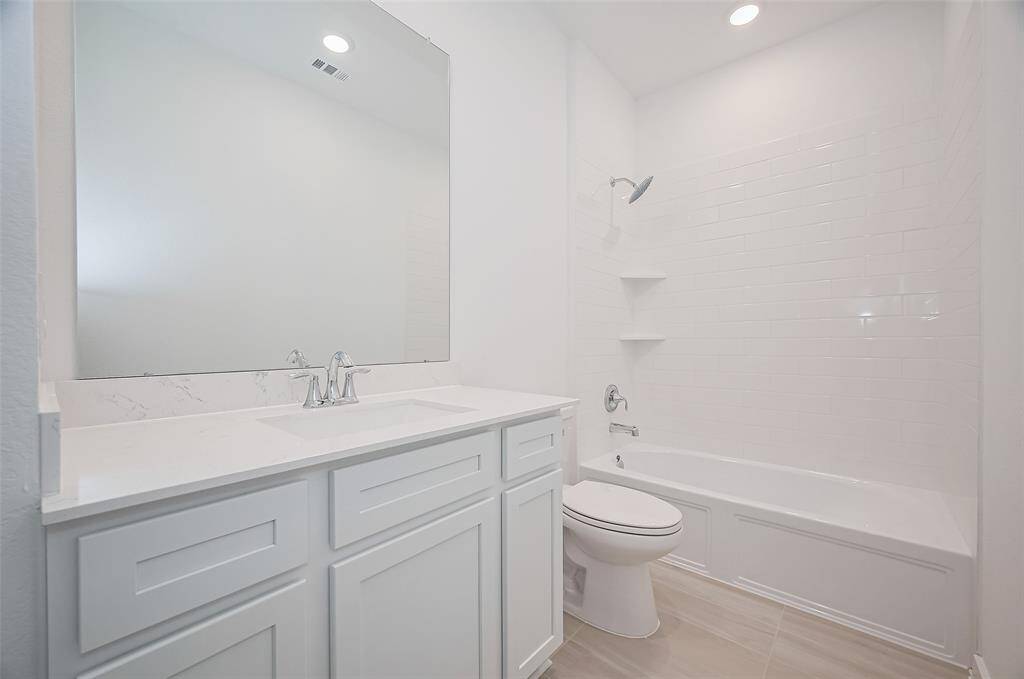 Well-appointed secondary bathroom with modern finishes.