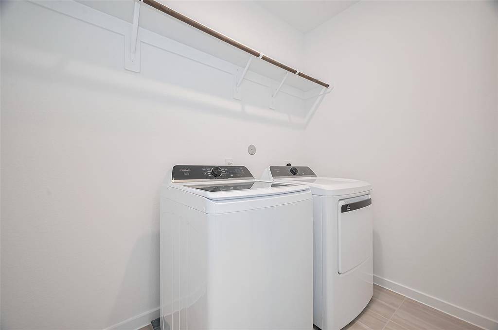 Fully equipped laundry space featuring a washer and dryer.
