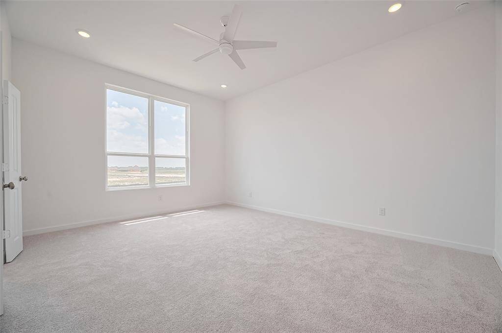 Spacious primary bedroom with plenty of natural light.
