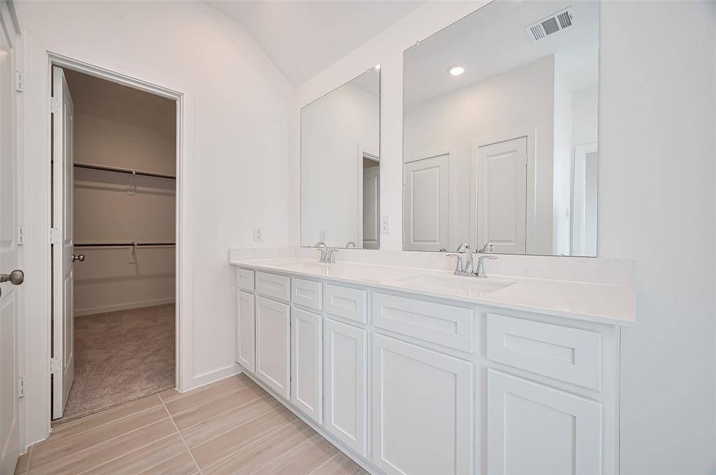 Elegant double sink setup with ample counter space.