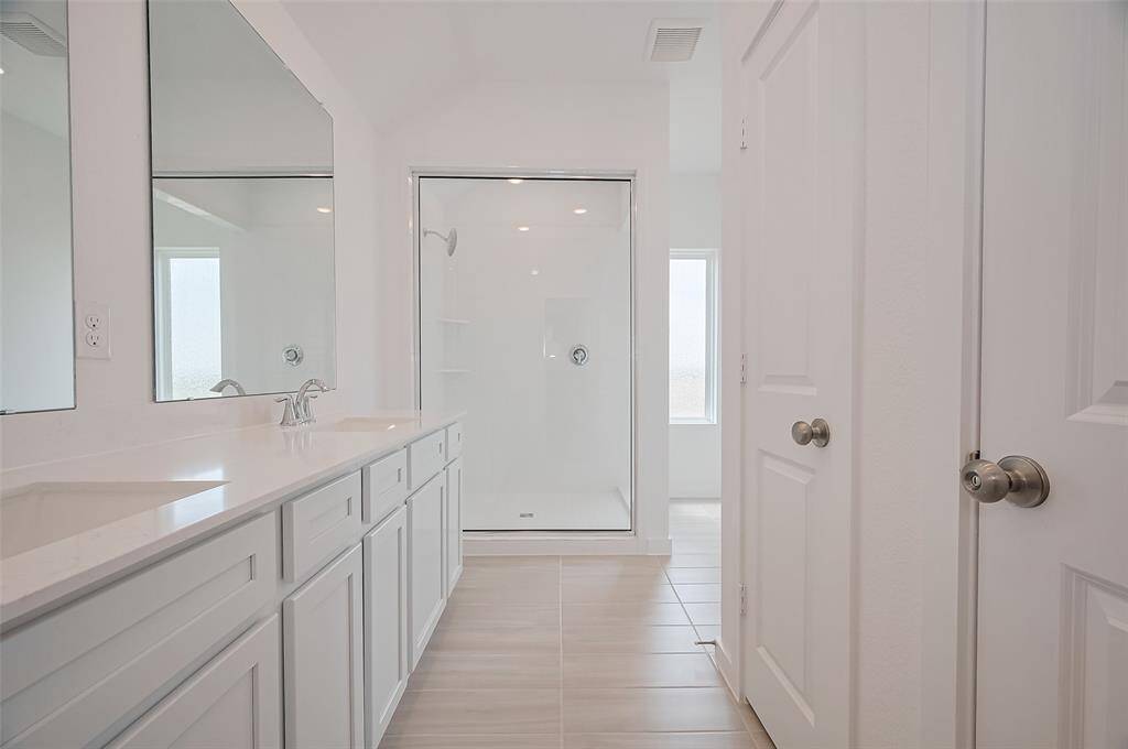 Modern design meets comfort in the spacious primary bathroom.